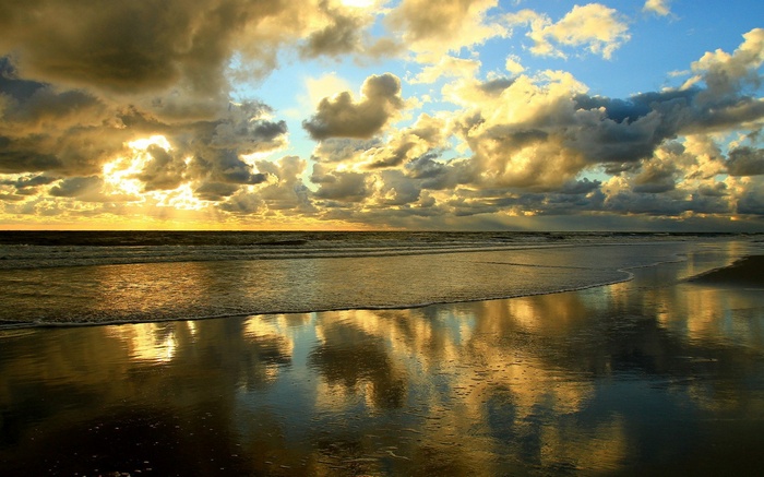 Sunset over the ocean with dramatic clouds