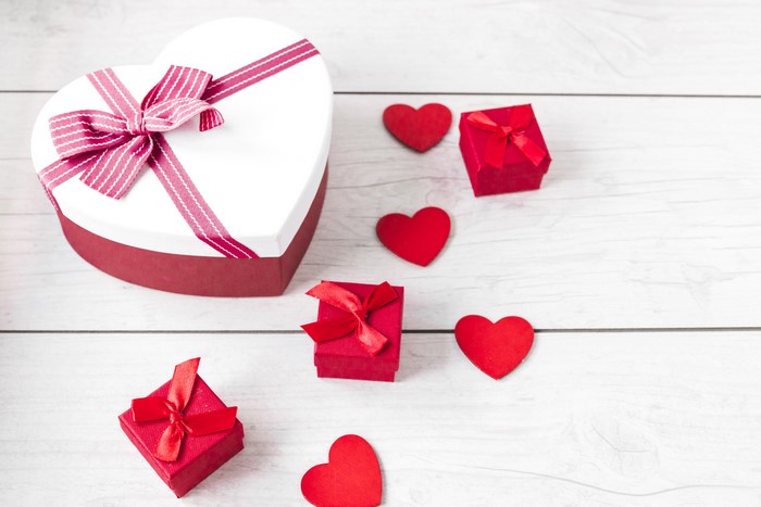 Heart-shaped gift box with red hearts and gifts