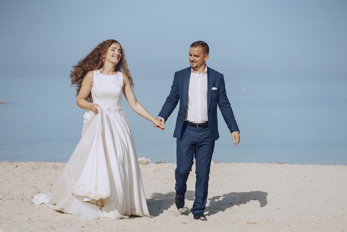 Bride and Groom Walking on Beach