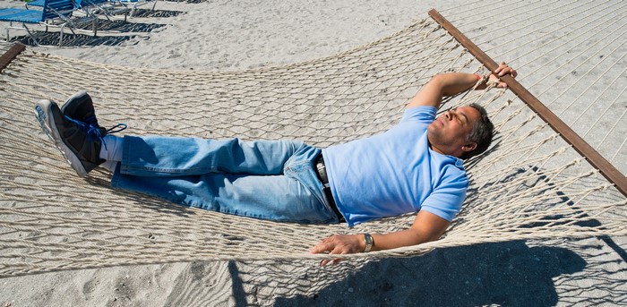 Man sleeping in a hammock on the beach