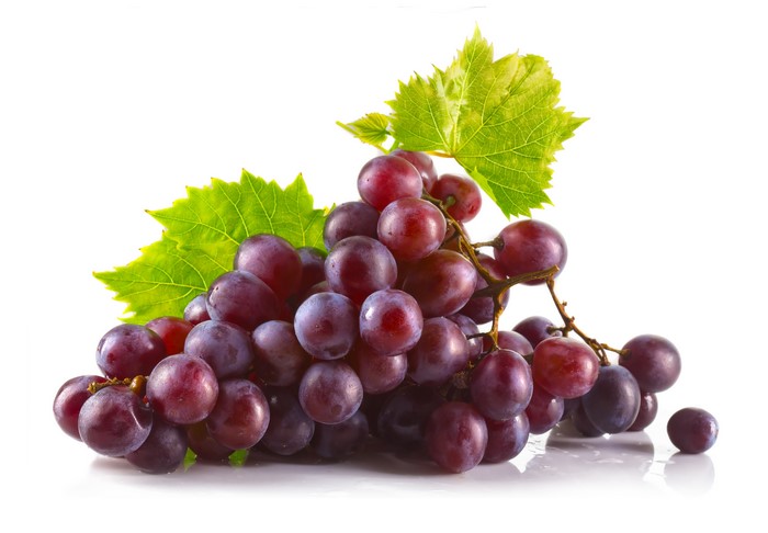 Grapes with leaves on white background
