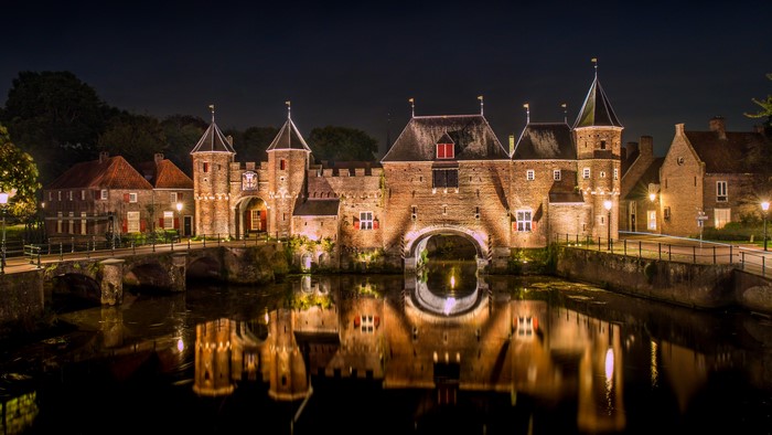 Koppelpoort gatehouse and canal in Amersfoort at night