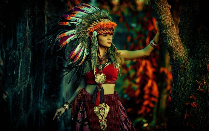 Woman in Native American Headdress in Forest