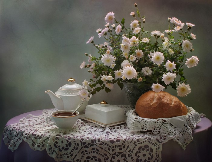 Still life with chrysanthemums, tea, and bread