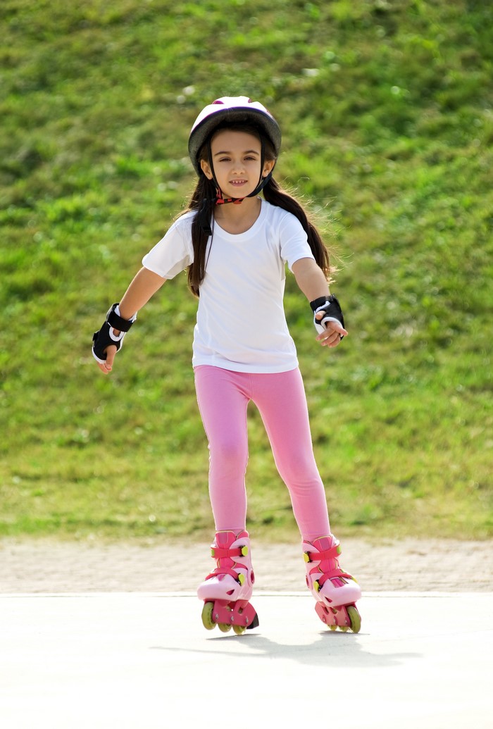 Girl wearing helmet and roller skates