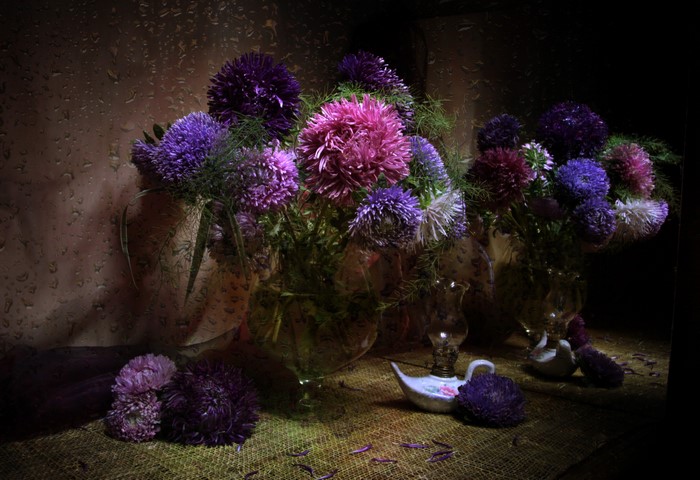 Asters in vases with a small oil lamp