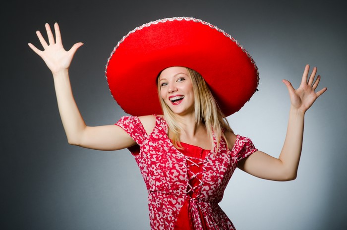 Blonde girl in a red sombrero and dress