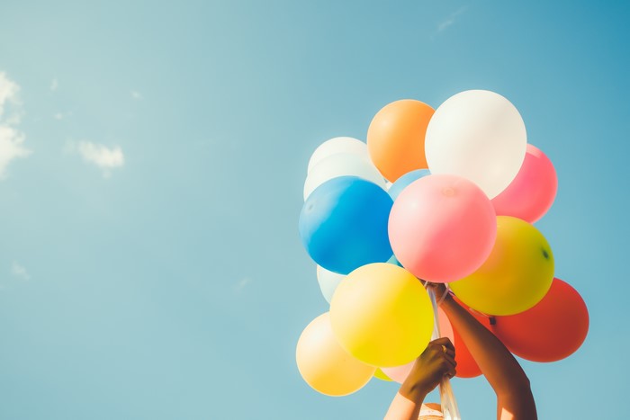 Bunch of colorful balloons against a blue sky