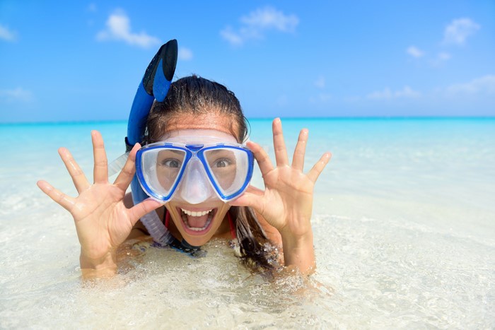 Brunette girl with snorkel mask in the sea
