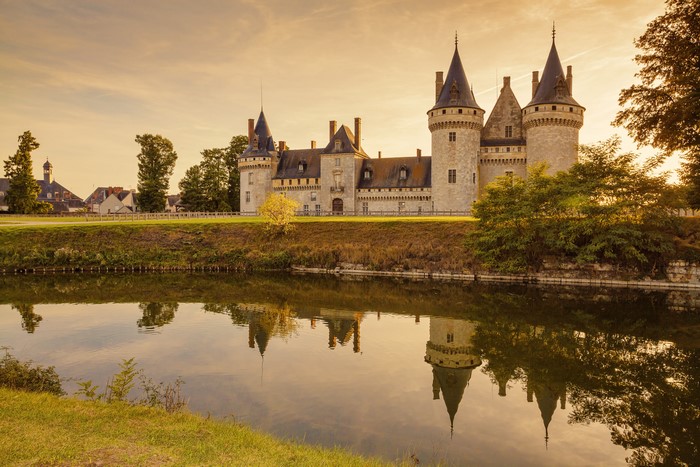 Chaumont Castle reflected in the river at sunset, France