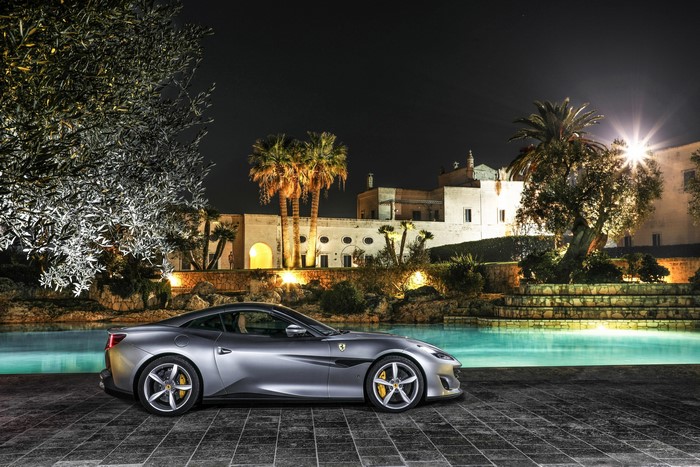 Grey 2018 Ferrari Portofino parked by a pool at night