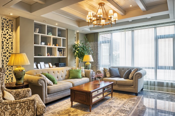 Living room with sofa, chandelier, and lamps