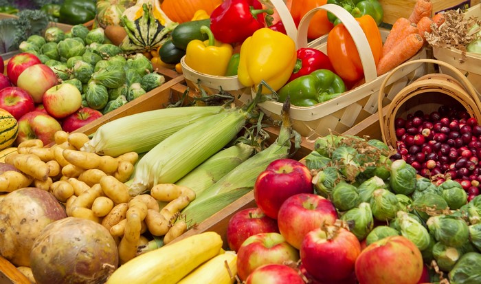 Assortment of Fresh Produce: Corn, Apples, Bell Peppers, Potatoes, and Cranberries