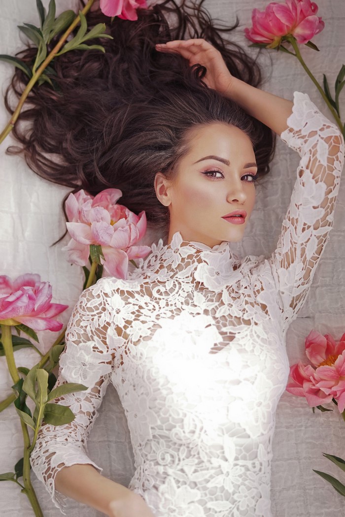 Woman with brown hair and peonies