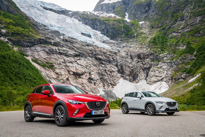 Two Mazda CX-3 cars in front of a glacier