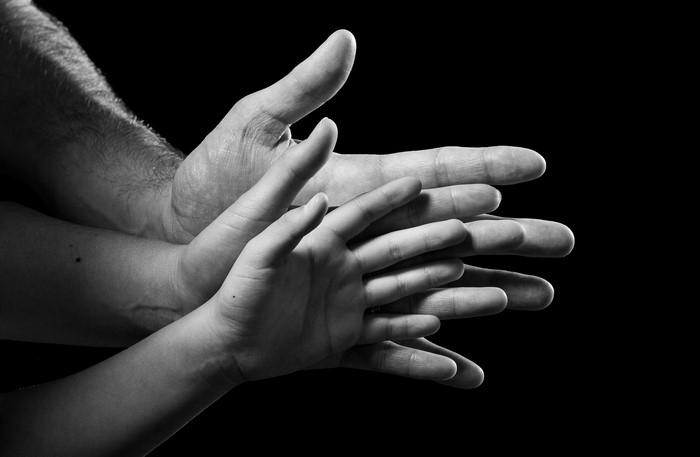 Multiple hands stacked together, close-up