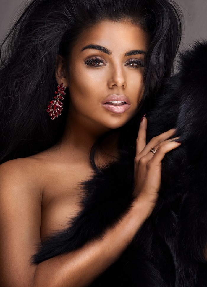 Woman with dark hair and red earrings