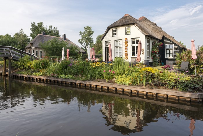 Thatched roof houses along a canal in Giethoorn, Netherlands