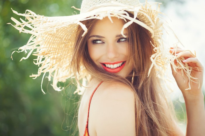 Beautiful Woman with Brown Hair Wearing a Straw Hat
