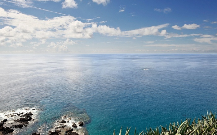 Ocean view with rocky shore and clouds