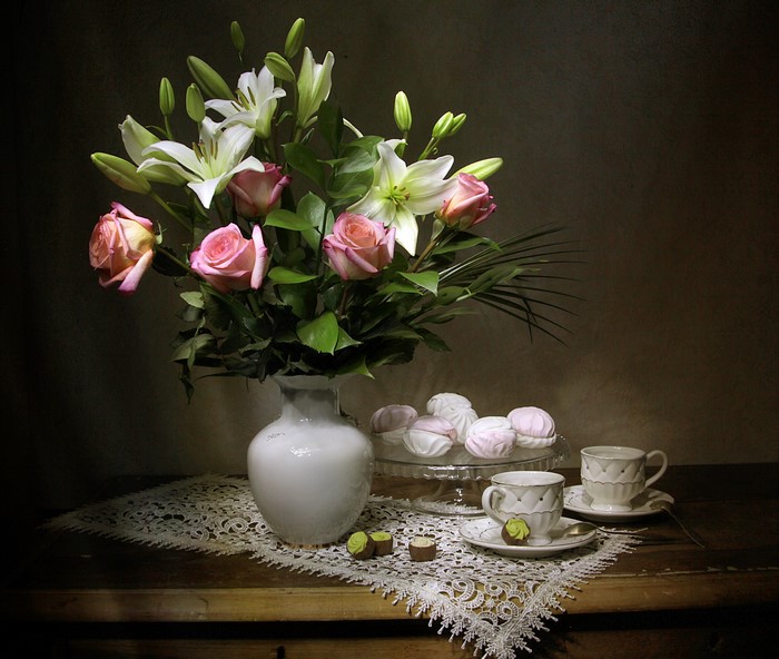 Still-life with roses, lilies, zefir, candy, vase, and cups