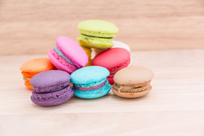 Assortment of colorful macarons on a wooden surface