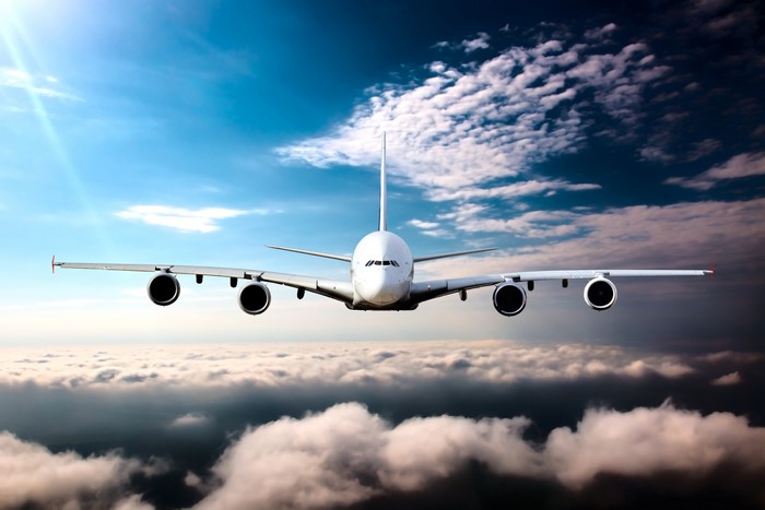 Airplane flying above clouds