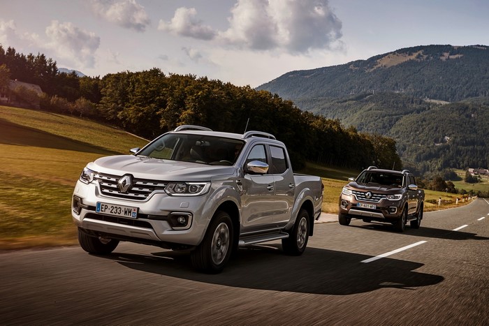 Two Renault Alaskan pickup trucks on a road