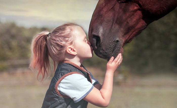 Girl kissing a horse