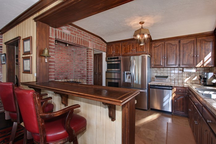 Kitchen with Bar and Brick Fireplace