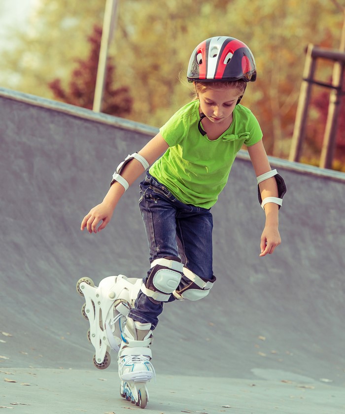 Girl in helmet roller skating