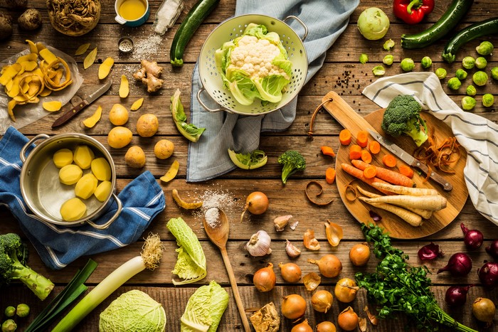 Vegetables on a wooden table with a cutting board