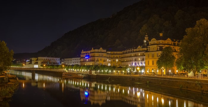 Night view of Bad Ems waterfront with illuminated buildings and river