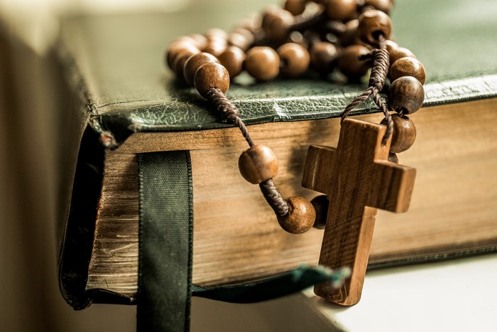 Rosary beads and cross on a book
