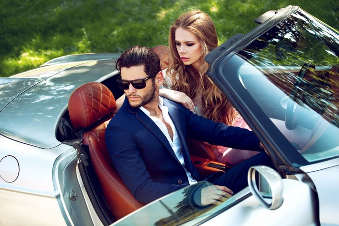 Man and woman in a convertible car