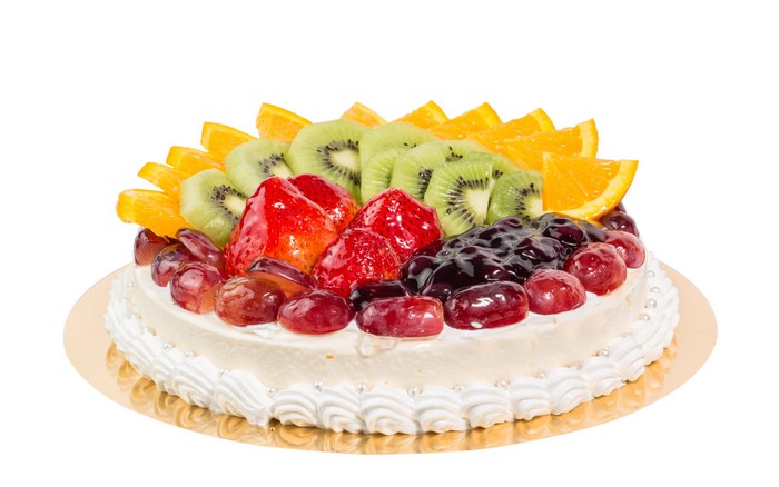 Fruit cake with strawberries, kiwi, oranges, and grapes