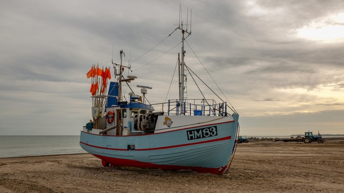 Fishing boat HM83 on a sandy beach
