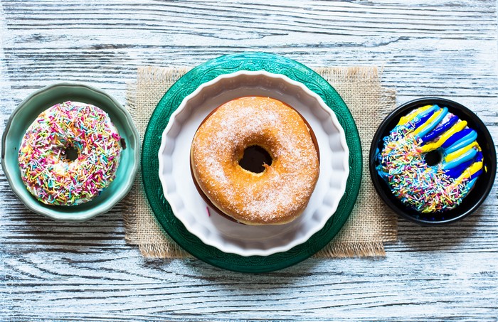 Three donuts on a wooden table