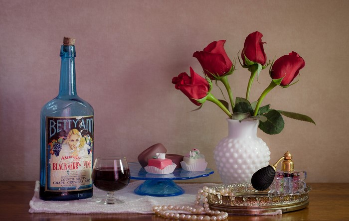Betty Ann Blackberry Wine bottle with roses and pastries