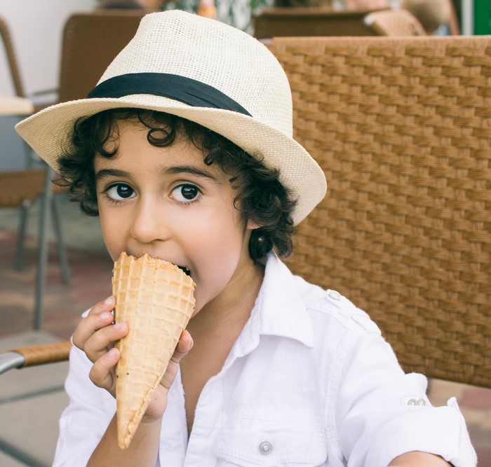 Boy in a Hat Eating an Ice Cream Cone