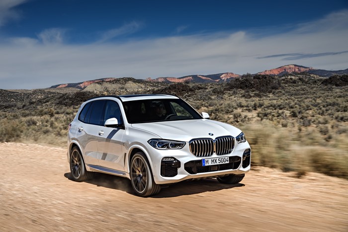White BMW X5 xDrive30d M Sport driving on dirt road