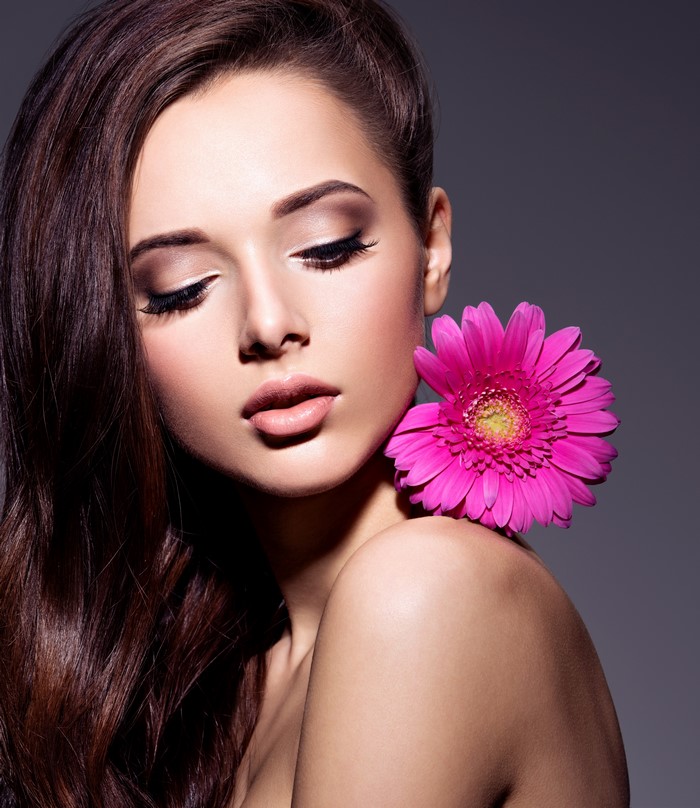 Woman with Brown Hair and Pink Gerbera Flower