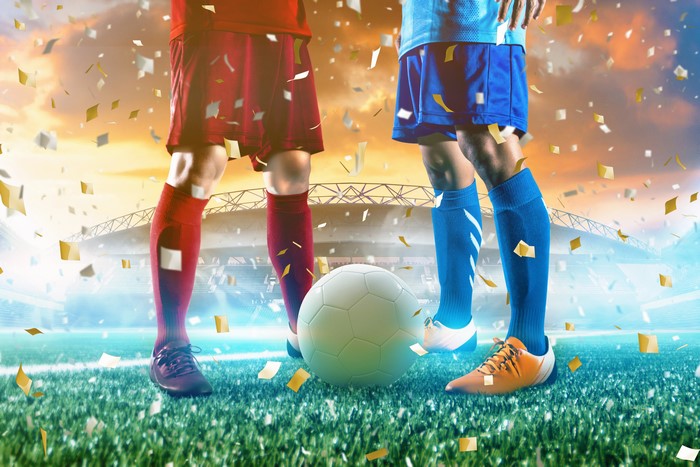 Soccer players with ball and confetti