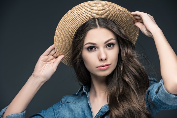 Woman in straw hat and denim shirt