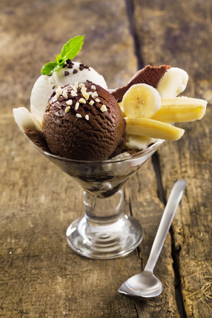 Chocolate and vanilla ice cream sundae with bananas and mint