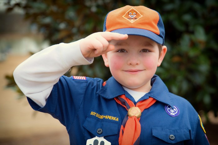 Boy Scout in uniform saluting