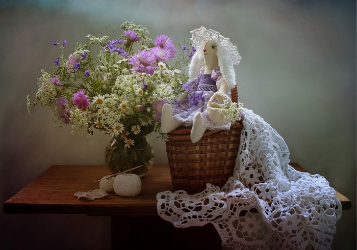 Still life with doll, flowers, and crochet
