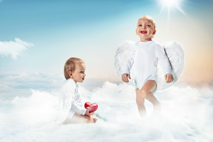 Two baby angels with wings and a heart