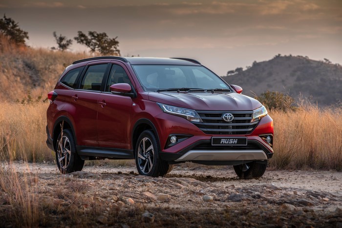 Red Toyota Rush SUV on a dirt road