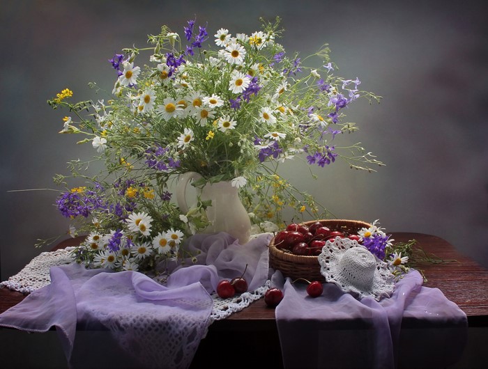 Still-life with bouquet of wildflowers and cherries